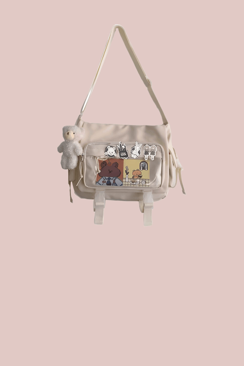 A beige cartoon-printed bag with a plush bear charm and buckle details. It’s the kind of accessory that feels like a childhood keepsake—whimsical, worn-in, and full of stories.