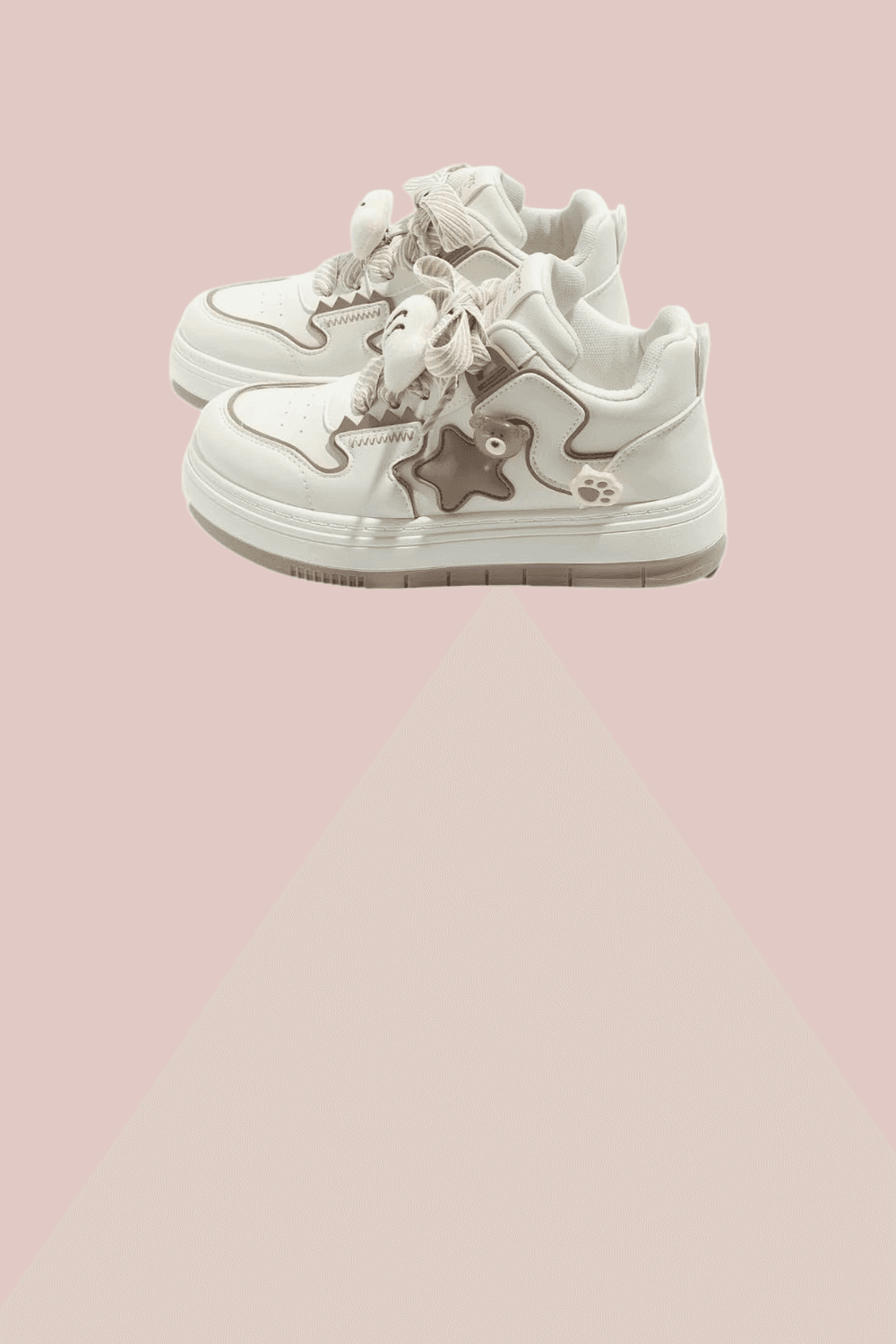 Chunky white sneakers softened by pink plaid bows and ruffled accents. These shoes ground the look while keeping it light—like stepping through a pastel dream with attitude.